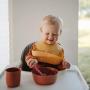 Mushie Silicone Baby Bib | Adjustable Fit Waterproof Bibs (Raw Sienna)