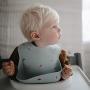Mushie Silicone Baby Bib | Adjustable Fit Waterproof Bibs (Raw Sienna)